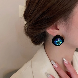 Gros plan sur des boucles d'oreilles carrées en velours avec strass sur un mannequin