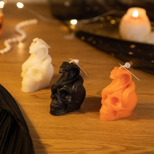 Handmade Halloween skull candles with cobra design in black, white and orange colors