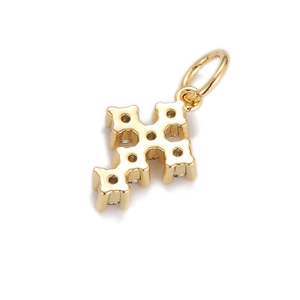 Macro detail of gold-plated hip hop cross pendant with geometric texture and metal ring