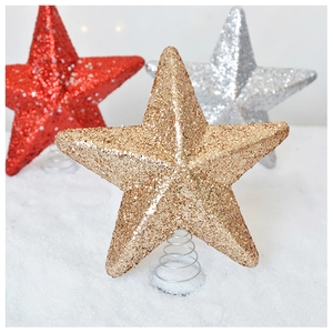 Close-up of glitter star tree toppers in gold, red and silver with spiral bases