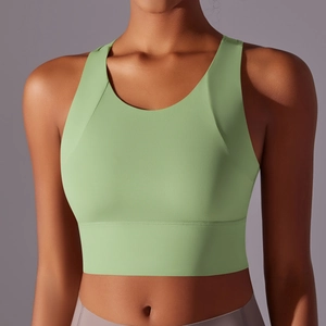 Detail of light green yoga sports bra featuring wide straps and moisture-wicking fabric