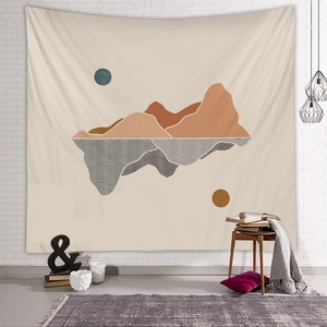 Detail of bohemian tapestry featuring abstract mountain layers and geometric sun pattern