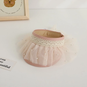 Detail of pink straw sun hat with white lace trim, mesh layer and pearl accents