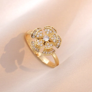 Elegant rotating sunflower ring in gold finish with sparkling clear cubic zirconia stones