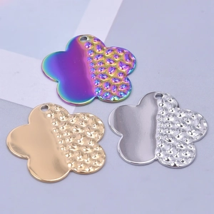 Detailed view of 18k gold plated flower pendants in silver, gold, and rainbow finishes