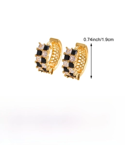 Detail showing checkered black and clear zircon inlay on gold copper hoop earrings