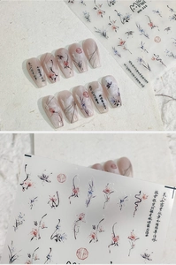 Detail of ink wash floral nail stickers featuring butterfly and calligraphy patterns