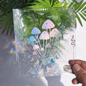 Detail of holographic mushroom and snake suncatcher sticker with rainbow prism effect