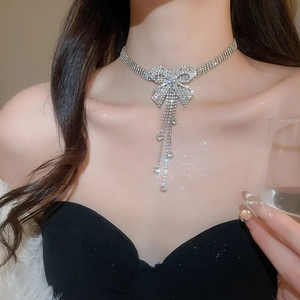 Detailed close-up of crystal bow choker with shimmering diamond-like fringe tassels