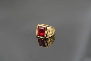 Macro shot of gold vintage men's ring with a large rectangular red gemstone setting