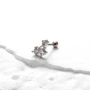 Detailed macro view of stainless steel stud earrings with sparkling zircon floral patterns