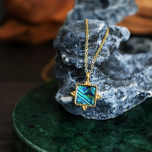 French vintage 18K gold plated necklace with square abalone shell pendant on grey rock