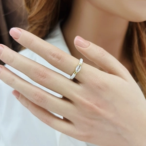 Close-up of white enamel teardrop ring with marquise zircon on model's finger