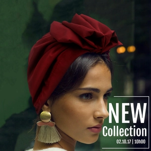 Detail of red floral turban with pleated design and bohemian golden tassel earrings