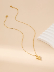 Detailed close-up of a gold stainless steel heart pendant on a fine O-link chain necklace