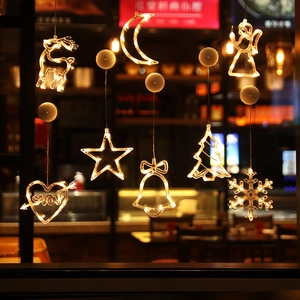Set of 8 warm yellow LED suction cup window lights with reindeer and star shapes