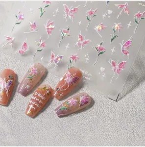 Detail of M-402 laser butterfly nail stickers on pink gradient manicure