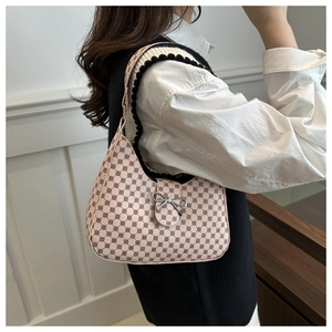 Detailed side view of pink crescent bag with geometric pattern and silver bow buckle
