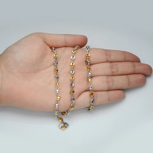 Detailed view of 5mm coffee bean link chain in gold and silver finish on hand
