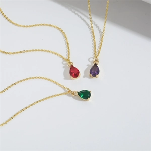 Minimalist gold necklace set with elegant red, purple, and green teardrop glass pendants