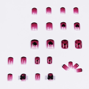 Faux ongles French courts avec pois violets, dégradé rose et nœuds papillon 3D noirs