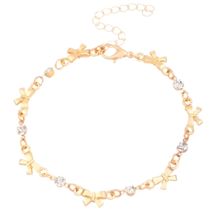 Golden bracelet for women featuring delicate bow charms and sparkling rhinestones on white background