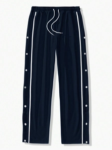 Detail of elastic drawstring waistband and functional side buttons on navy sports pants