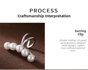 Detailed view of silver ear cuff with five white pearls in a minimalist smile design