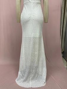 Close-up of white sequined fishtail evening dress showing shimmering texture and fabric