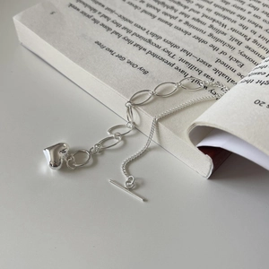 Sparkling S925 sterling silver heart bracelet with toggle clasp on book background