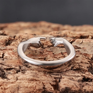 Artistic silver hand-to-hand ring inspired by The Creation of Adam on wood bark