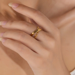 Detailed view of dual-band gold ring featuring a pig nose anchor chain design on finger