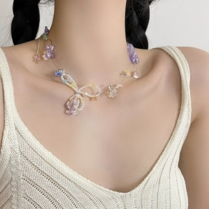 Floral beaded necklace with purple and blue crystals and a butterfly pendant for women