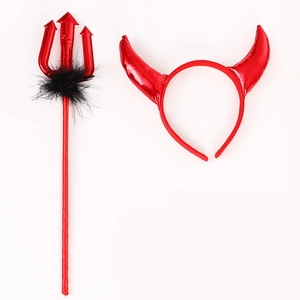Close-up of red devil horn headband and matching trident with black feather details
