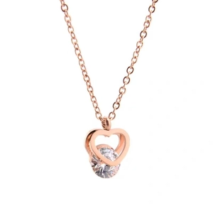 Rose gold titanium steel heart pendant necklace with sparkling crystal on white background