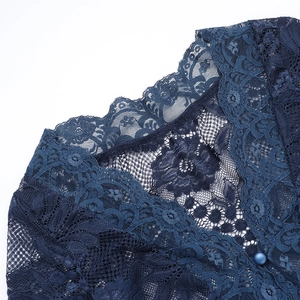 Detail of navy blue floral lace fabric featuring exquisite buttons and elegant texture