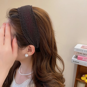 Detail showing the brown woven wide headband texture and French vintage style on model