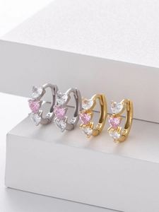 Macro view of S925 sterling silver hoop earrings with pink and clear heart zircons