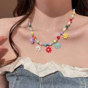 Detailed shot of a colorful beaded daisy necklace with five vibrant flower pendants