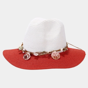 Detail of contrast straw sun hat featuring white crown, red brim and shell decoration