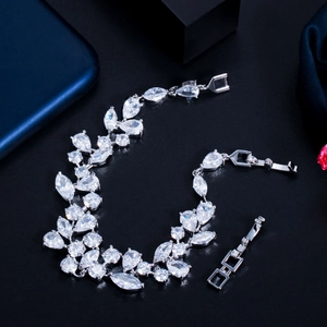 Detailed view of silver leaf bracelet with pear-shaped cubic zirconia on black texture