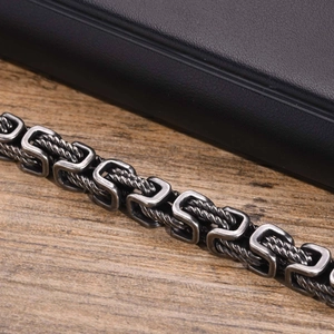 Macro view of men's vintage Byzantine chain with twisted rope texture and silver black finish