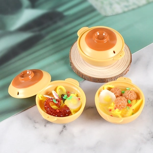 Detailed view of miniature food models showing ramen and meatballs in tiny clay pots