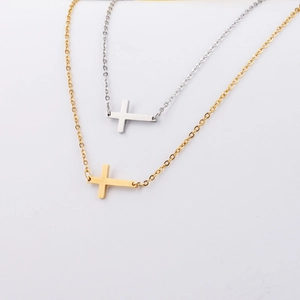 Detail of horizontal cross pendants on fine O-chains in gold and silver finishes