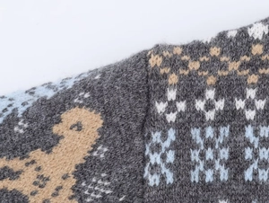 Macro shot of high-quality dark grey jacquard knit fabric with geometric patterns