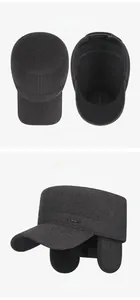 Detail of dark grey winter wool flat top hat featuring sport metal plate and ear flaps