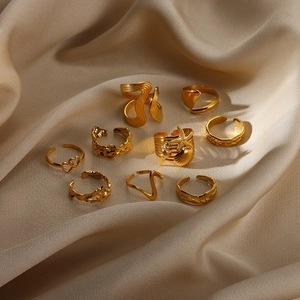 Detailed set of 9 golden rings featuring starfish and shell motifs on champagne silk