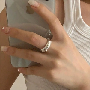 Macro shot of silver S925 sterling silver ring with 3D geometric triangle pattern detail