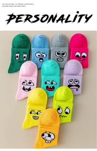 Flat lay of colorful ribbed sports socks with cartoon smiley faces in ten vibrant colors