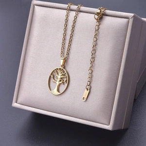 Macro detail of golden stainless steel tree of life pendant on jewelry box